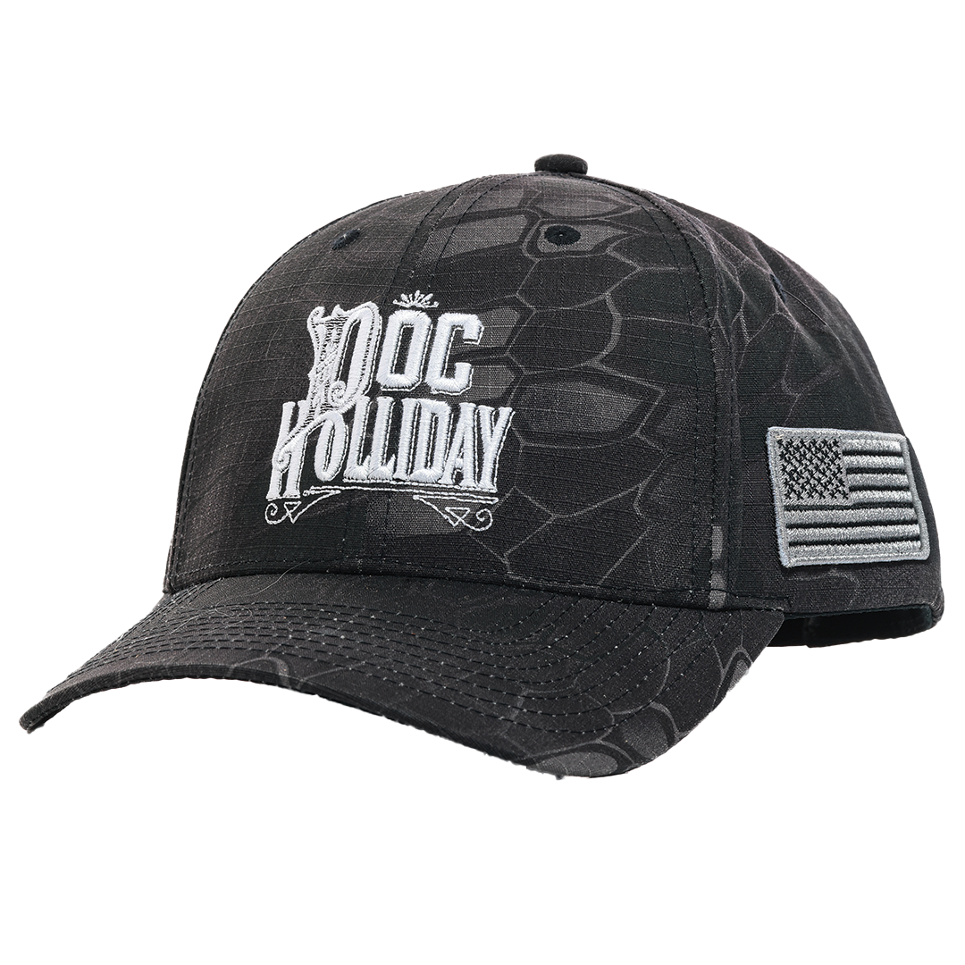 Black and dark gray reptile-patterned baseball cap featuring a white embroidered 'DOC HOLLIDAY' logo on the front and an American flag patch on the side.