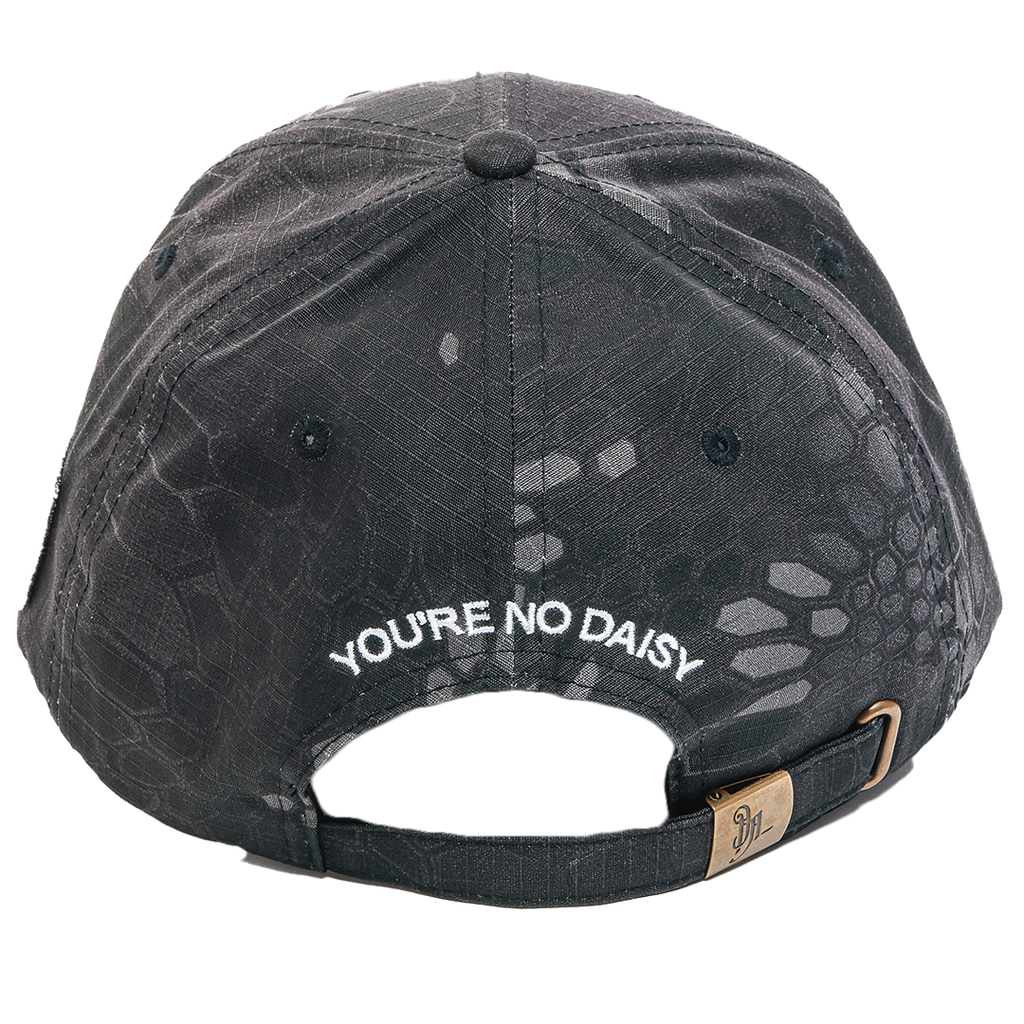 Back view of a black textured baseball cap with white embroidered text reading 'YOU'RE NO DAISY' and a small gold-toned brand tag on the adjustable strap.