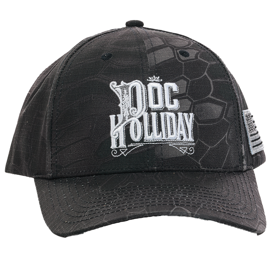 A black baseball cap featuring a textured alligator skin pattern and a white embroidered logo on the front that reads 'DOC HOLLIDAY'. The side of the cap has a small embroidered American flag patch.